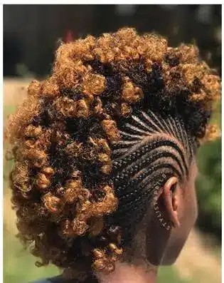 Side view of person with braided undercut and curly top in outdoor setting
