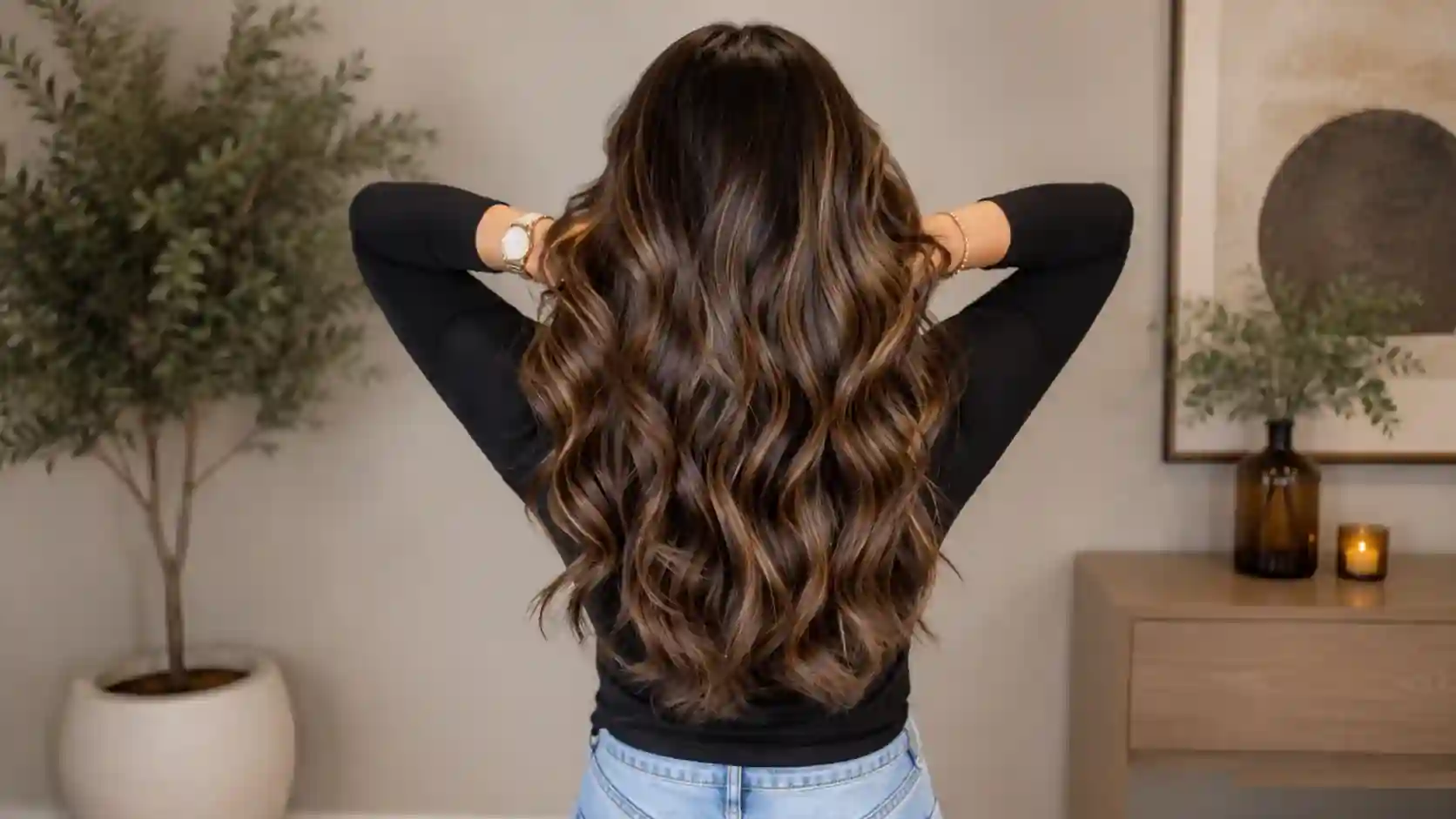 Rear view of long wavy hair with Caramel Balayage highlights, soft dimension, glossy finish, and natural salon-style movement.
