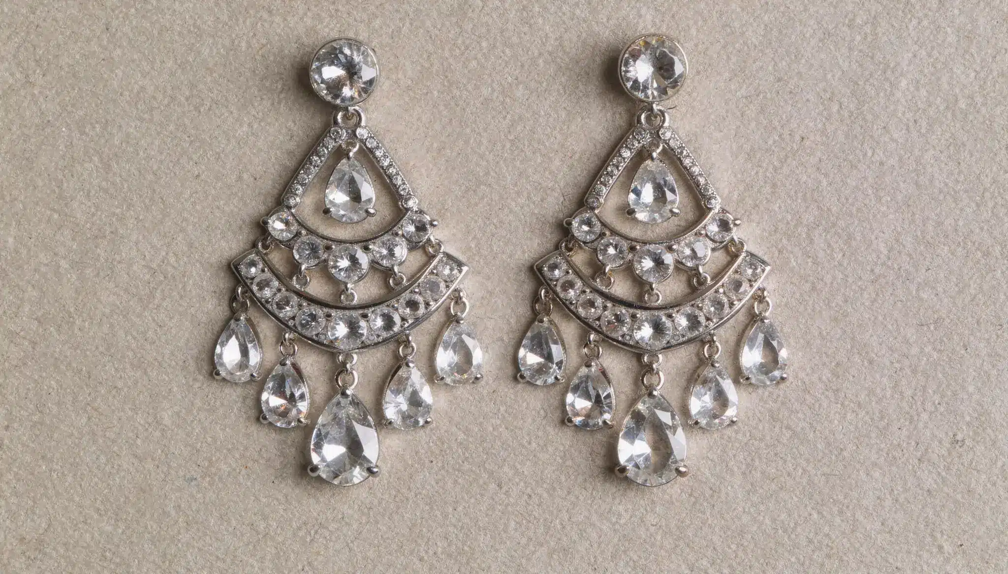 Silver chandelier earrings with multiple clear rhinestones and teardrop dangles