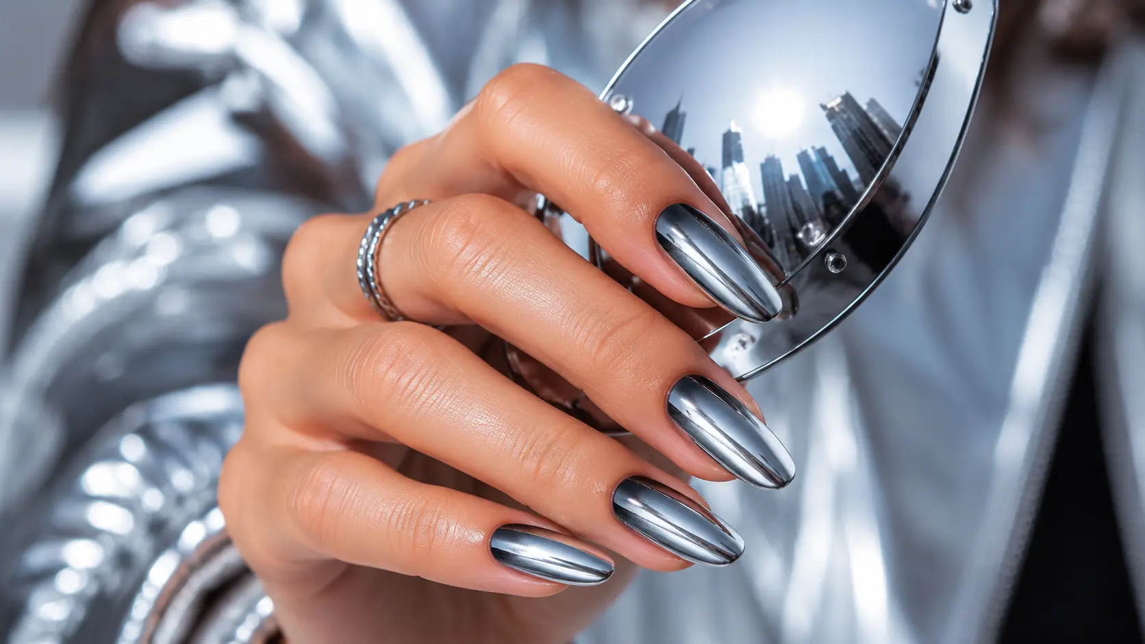 Chrome ombre nails holding mirrored sunglasses