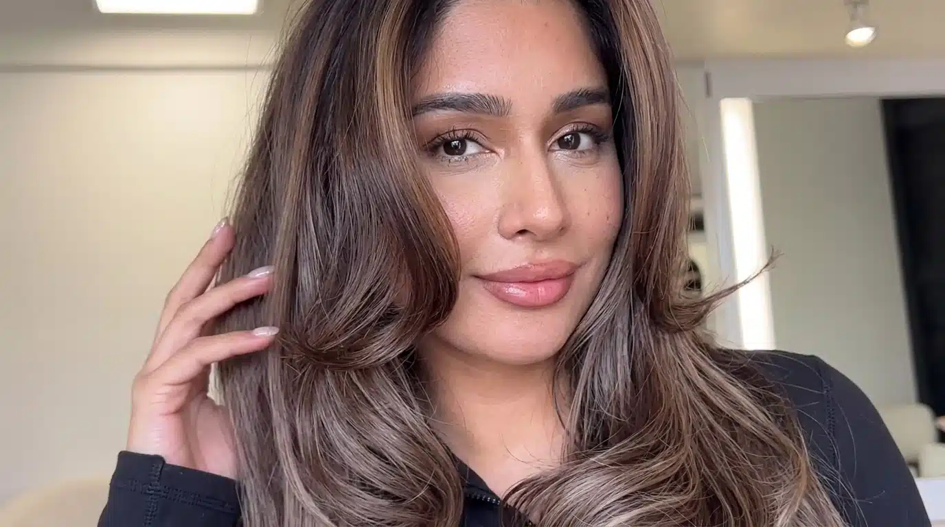 Female with cool mocha balayage adding soft dimension to dark hair.