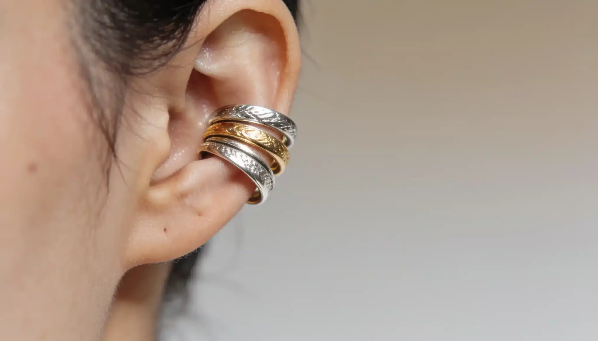 Gold and silver ear cuffs wrapping the outer ear, easy to layer.