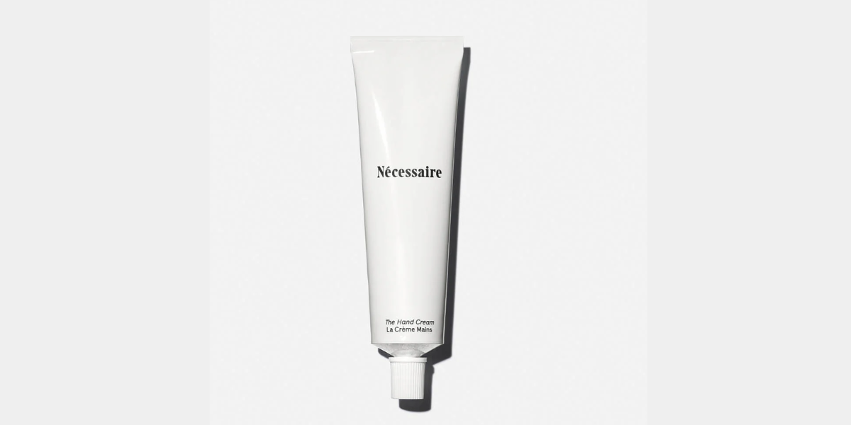 White Nécessaire tube with peptides and niacinamide for soft, nourished hands.