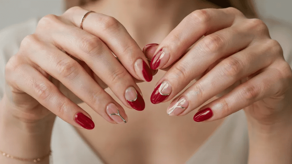 Almond nails with negative space designs showing natural nail alongside painted sections, modern style.