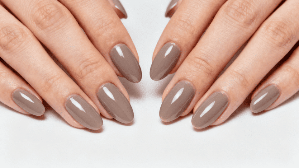 Almond-shaped nails in neutral color with high-gloss shine, polished elegant manicure.