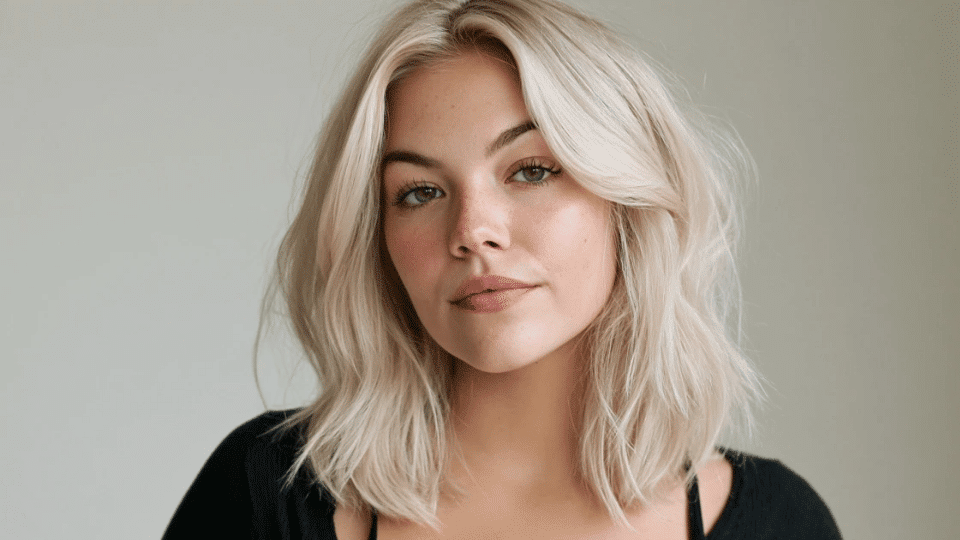 Woman with medium-length hair featuring platinum blonde highlights around the face.