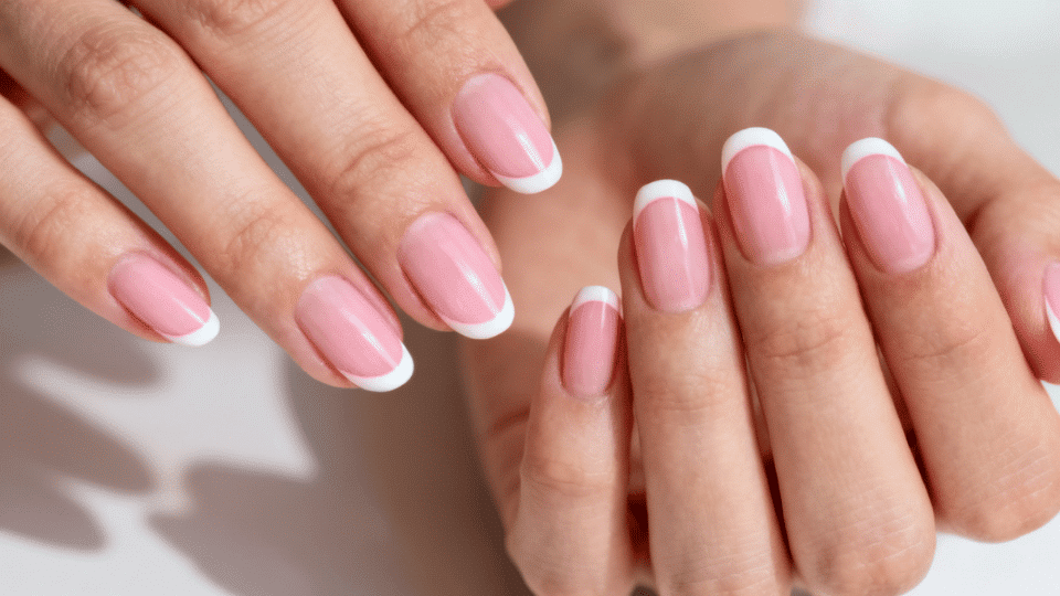 Almond-shaped nails with soft pink French tips, delicate refined manicure for brunch or weddings.