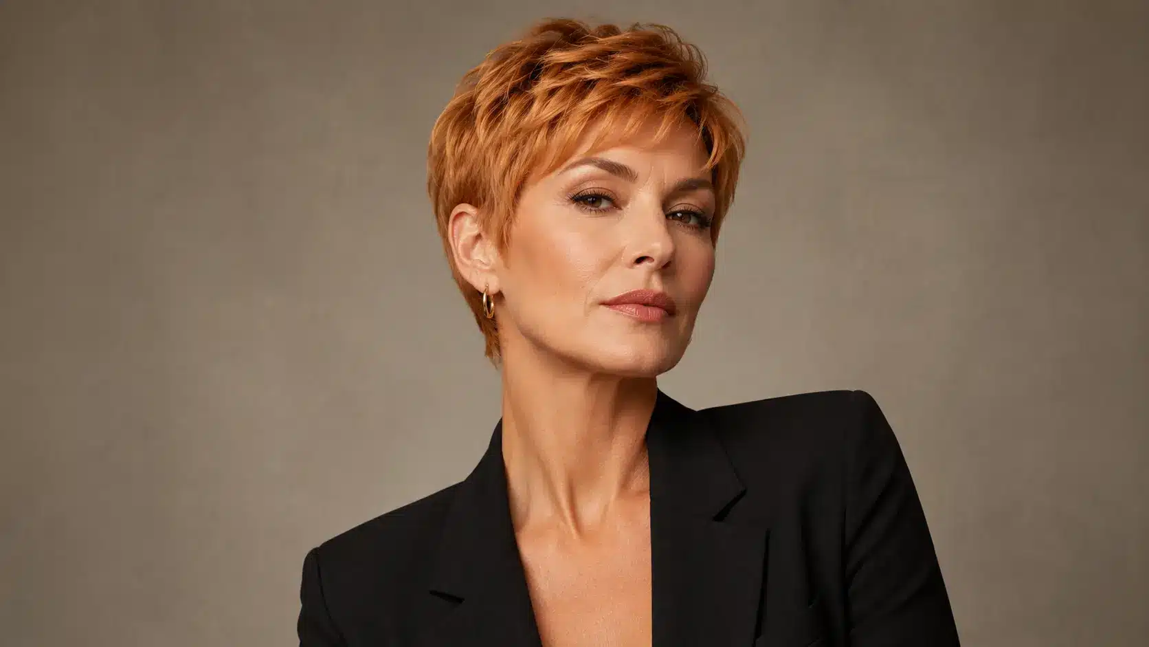 Strawberry blonde pixie cut with modern styling