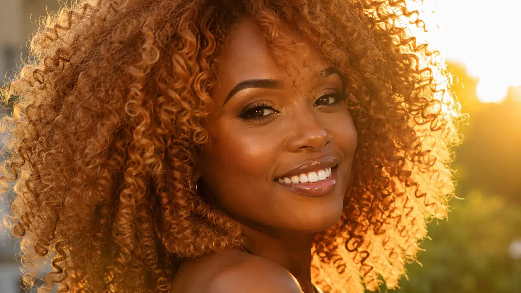Voluminous strawberry blonde curls with warm tones