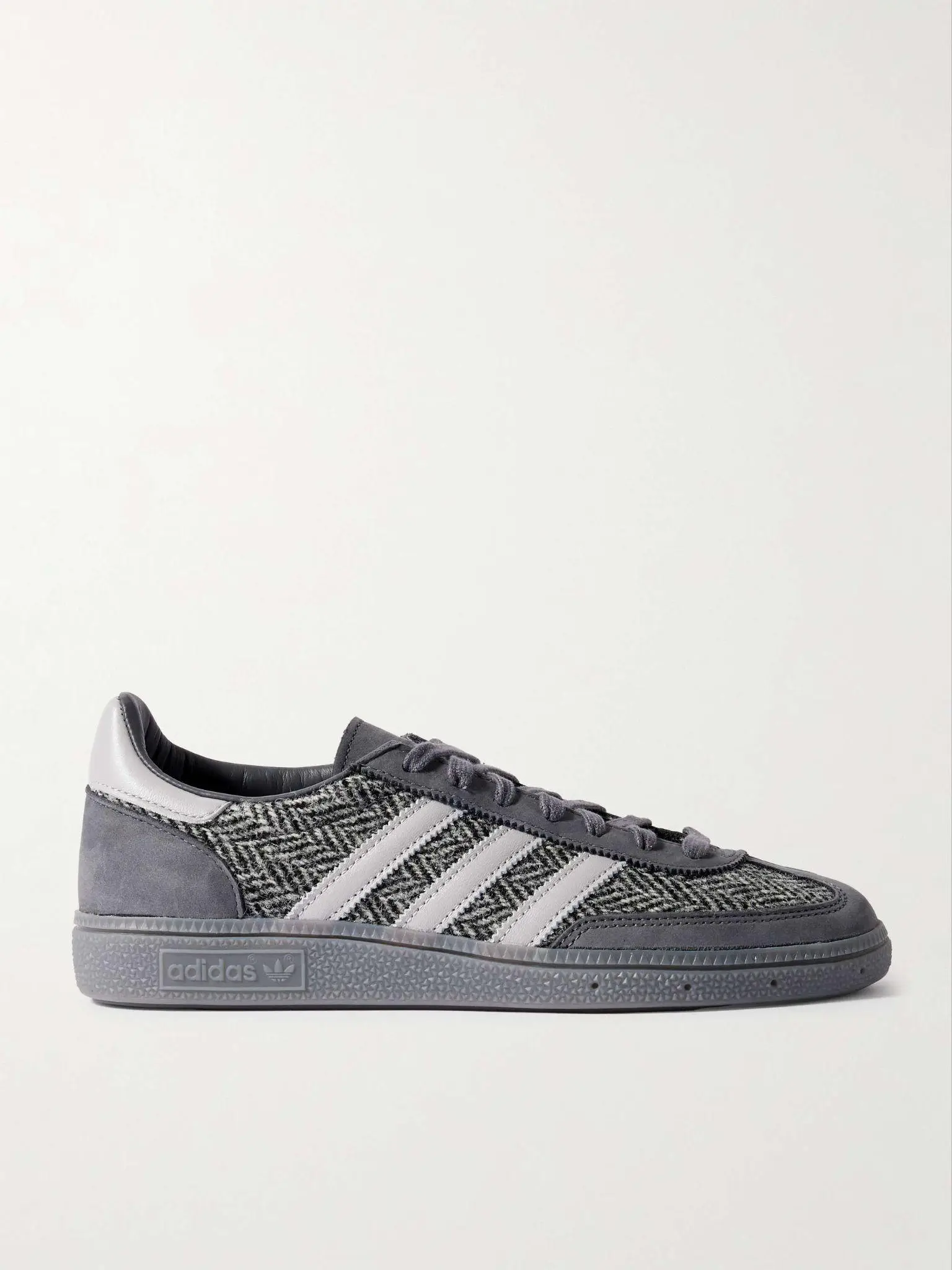 Gray and white woven sneaker with textured sole on plain background