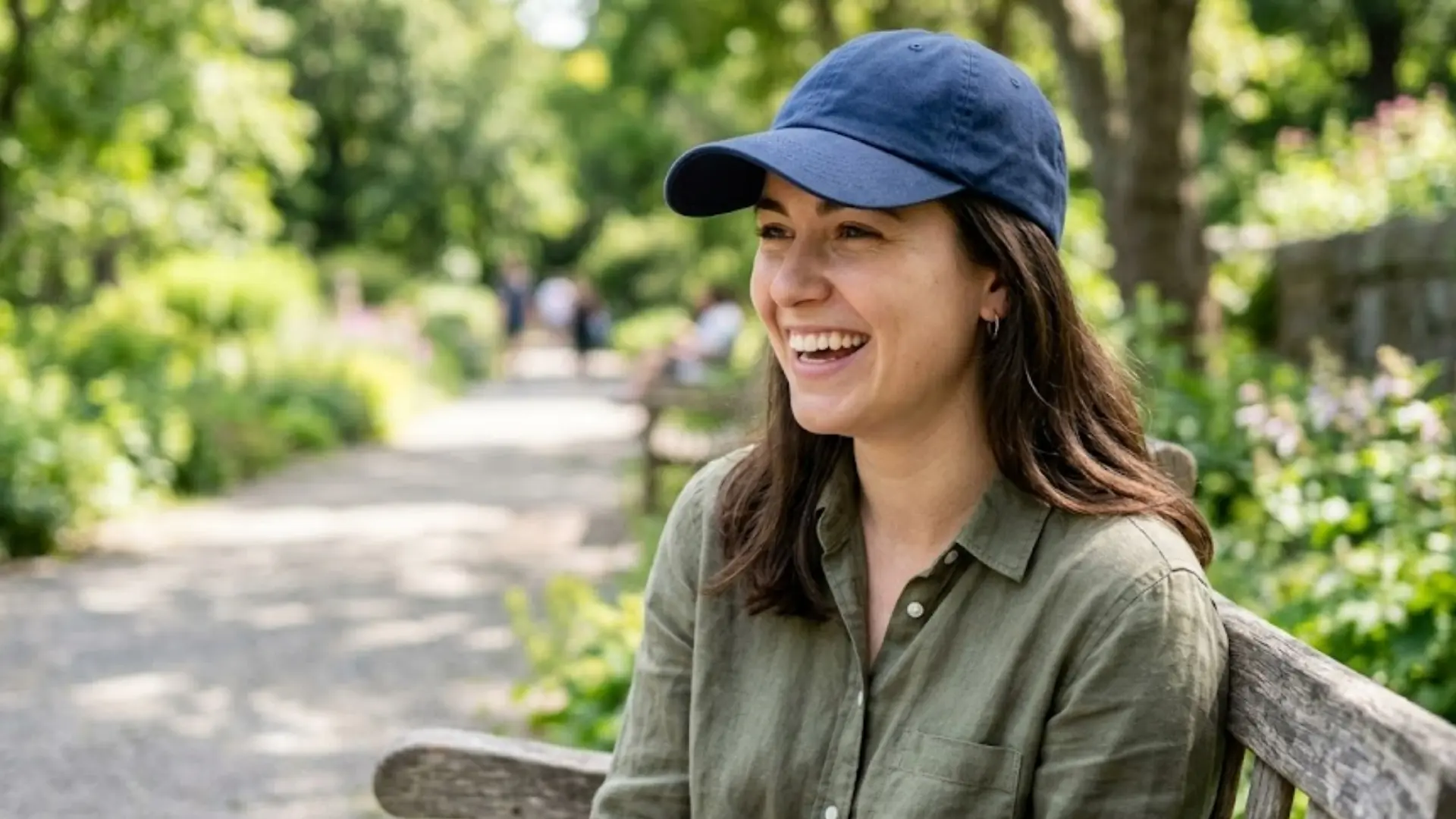 a woman wearing a well-fitted cap outdoors showing healthy hair and safe hat habits for hair care